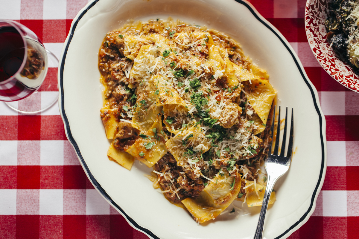 overhead photo of a pappardella pasta with a fork resting on the edge of a plate