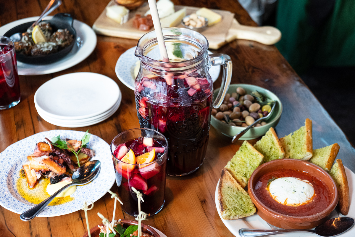 Table with a Sangria pitcher surrounded by various menu items